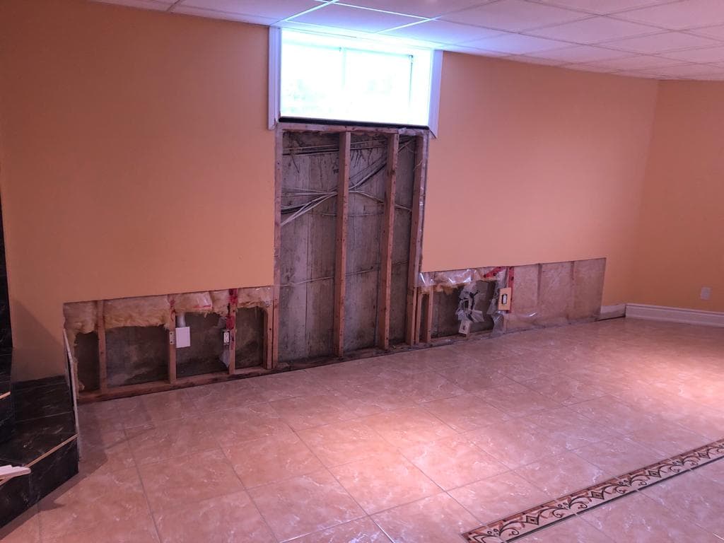 Basement wall opened to the studs during drywall repair and installation